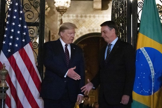 President Donald Trump shakes hands before a dinner with Brazilian President Jair Bolsonaro at Mar-a-Lago, Saturday, March 7, 2020, in Palm Beach, Fla. (AP Photo/Alex Brandon)
