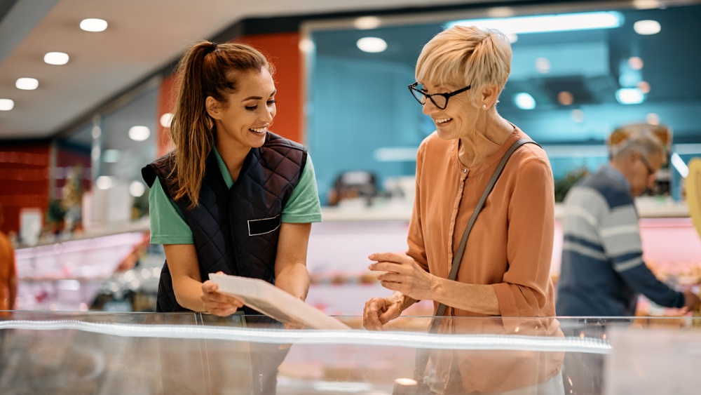 A woman shows another woman document.