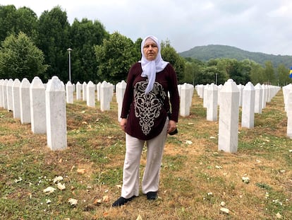 Mirzeta Karic, in front of the graves at the Srebrenica-Potocari cemetery, where the remains of her uncle and father lie, Wednesday, July 9, 2025.