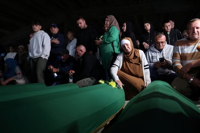 A Bosnian woman cries next to the coffin of a relative to be buried at the mass funeral for the 30th anniversary of the Srebrenica genocide in Potocari, Bosnia and Herzegovina.