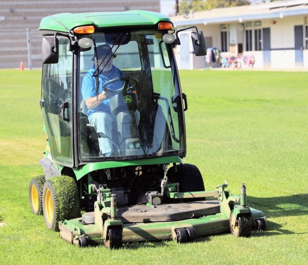 Former Fullerton School District Superintendent Duncan Johnson rides a lawn...