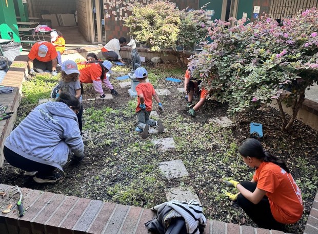 Volunteers work on garden centers at Greenville Fundamental School in...