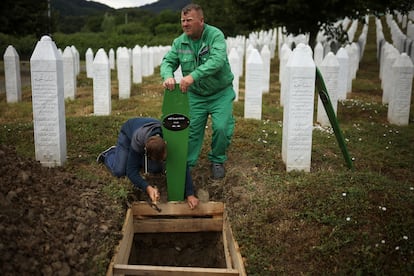 Cemetery workers prepare graves for the mass burial of seven newly identified victims of the 1995 Srebrenica genocide in Potocari, Bosnia, Thursday.