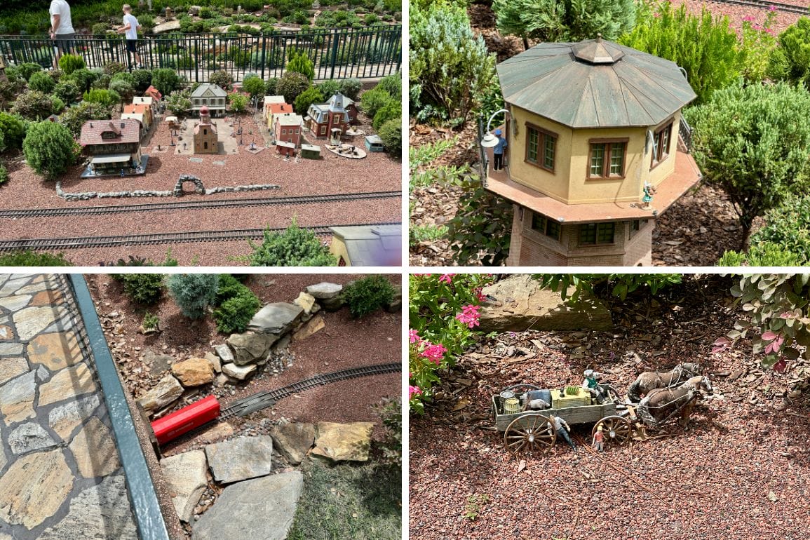 Model train village at EPCOT with miniature buildings, red train, and wagon—perfect for any photo report among plants and rocks.