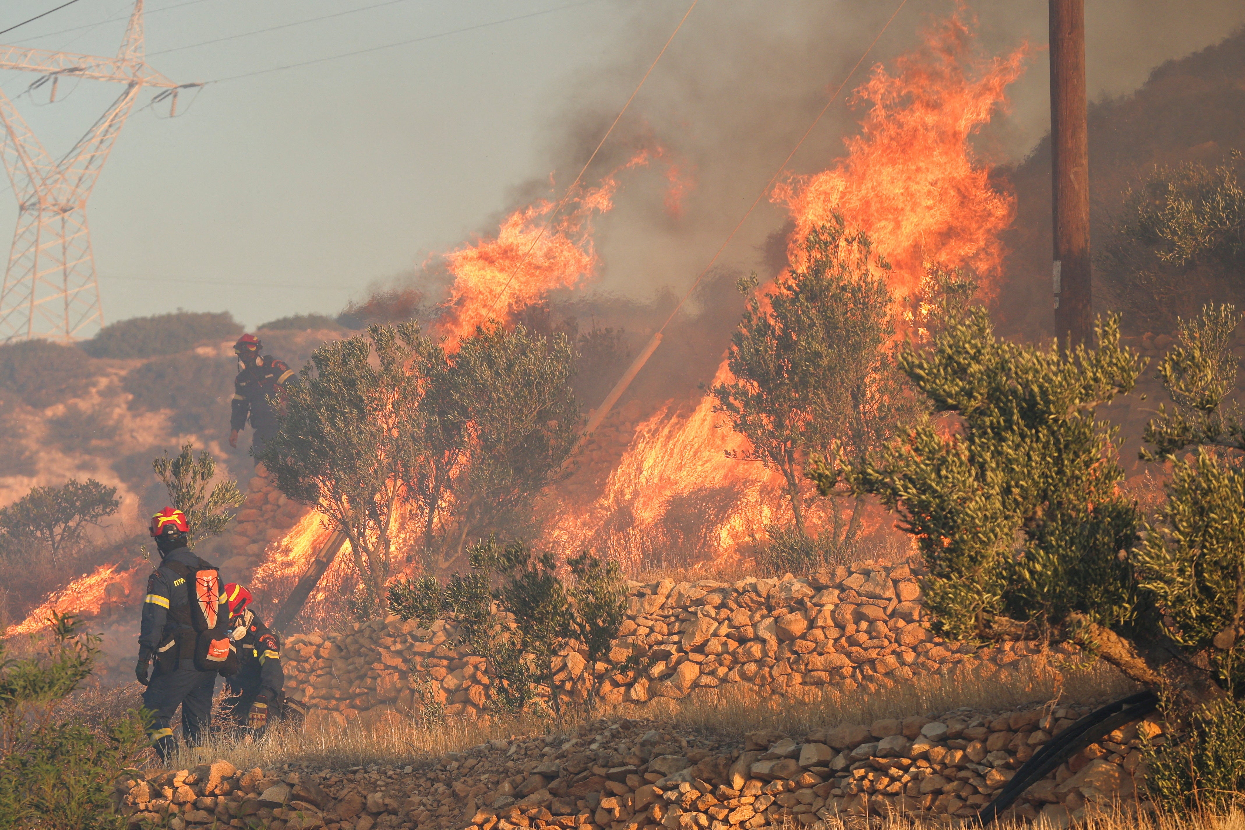 Firefighters tackle the huge inferno near Ierapetra, on the island of Crete