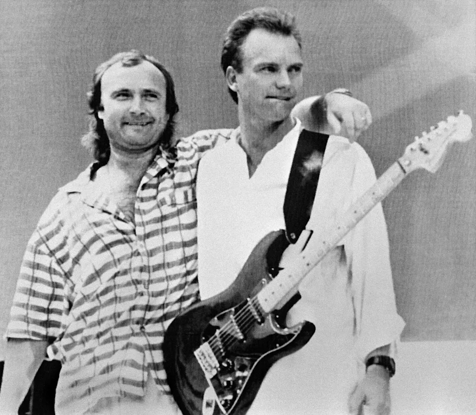British singers Phil Collins (L) and Sting pose after performing on July 13, 1985 at Wembley Stadium in London during the "Live Aid" concert.