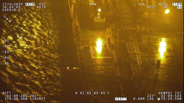 An oil tanker responded to the call for assistance, using ladders to rescue the crew. 