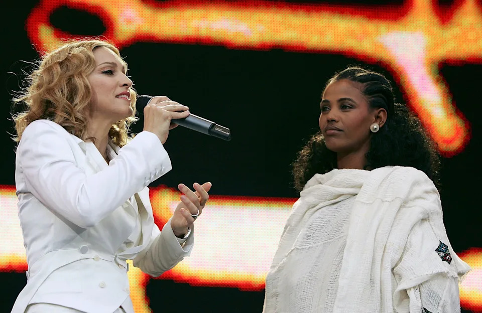 Madonna and 24-year-old student Birhan Woldu, former Ethiopian famine victim and the inspiration for Live Aid 1985, are seen on stage during "Live 8 London" in Hyde Park on July 2, 2005, in London, England.
