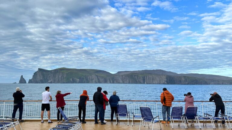 Guests on Hurtigruten's MS Trollfjord looking at Bear Island. Photo: David Nikel.