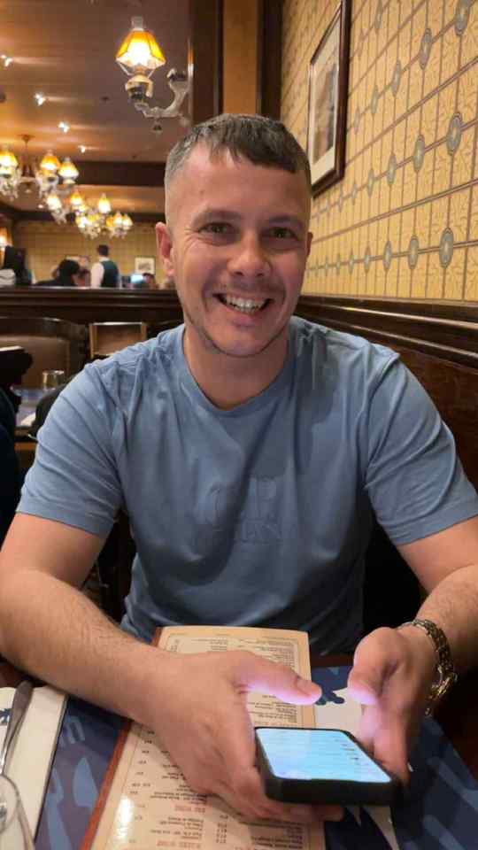 Man looking at his phone in a restaurant.
