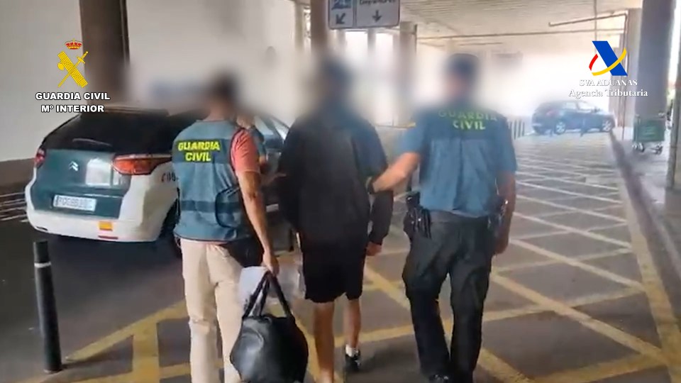 A British man being arrested by Spanish police for drug smuggling.