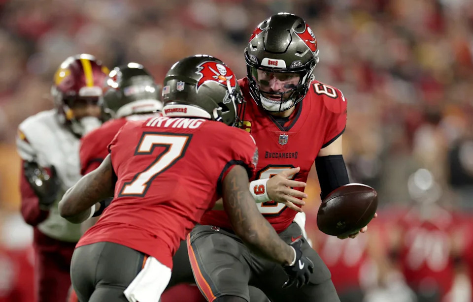Tampa Bay Buccaneers quarterback Baker Mayfield (6) hands off to running back Bucky Irving (7) during a game.© Nathan Ray Seebeck-Imagn Images