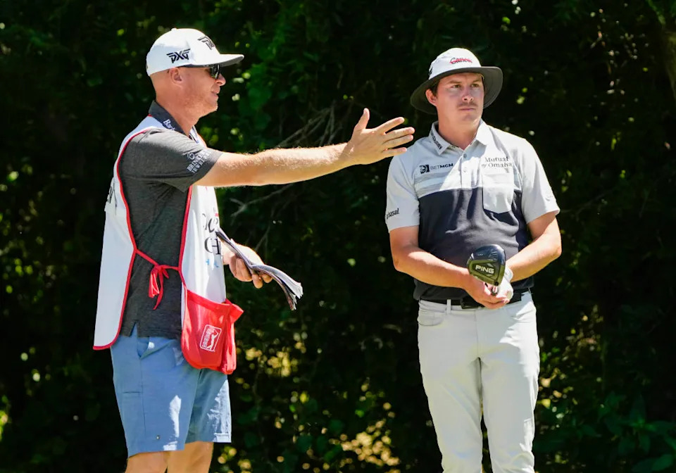 Joel Dahmen (right) and caddie Geno Bonnalie on the sixth tee during the first round of the Charles Schwab Challenge golf tournament.© Jim Cowsert-Imagn Images