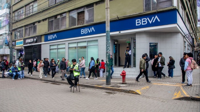 Brussels gives Spain legal warning for blocking BBVA-Sabadell bank merger BBVA bank and pedestrians