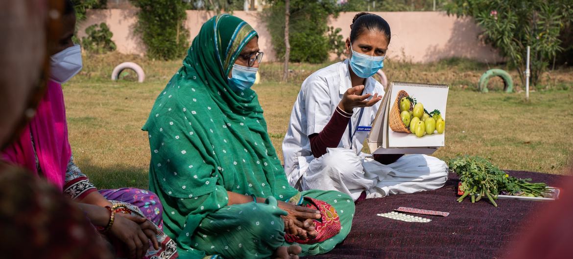 A nurse speaks to women about nutritious food in western India's Sabarkantha district, were many women and girls suffer from iron deficiency.