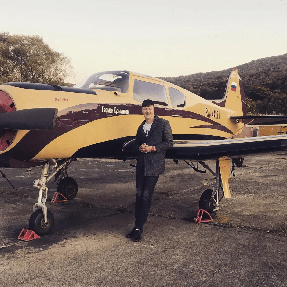 Man standing next to a small plane.