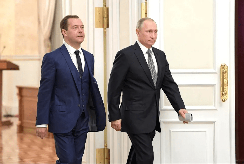 Vladimir Putin and Dmitry Medvedev walking together.
