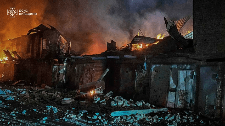 Burned-out building at night.