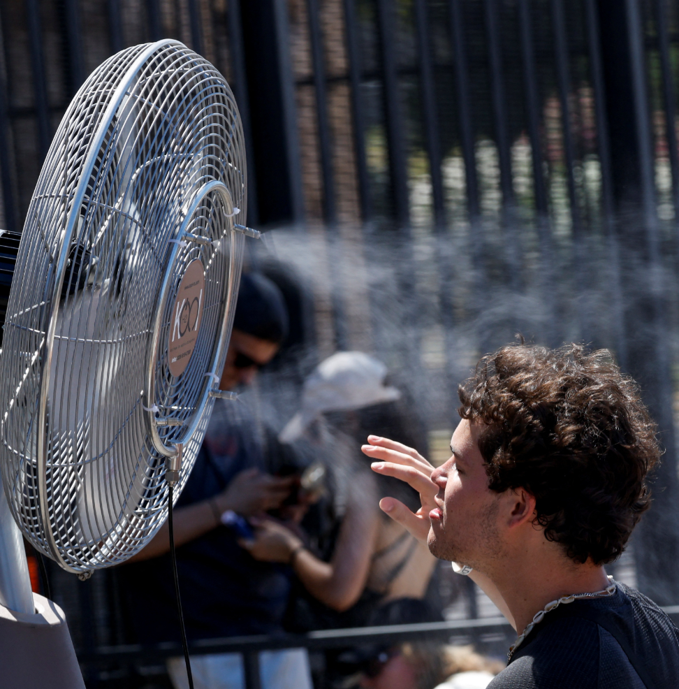 In Rome on Monday, tourists were seen taking breaks in front of cooling fans installed along the streets.