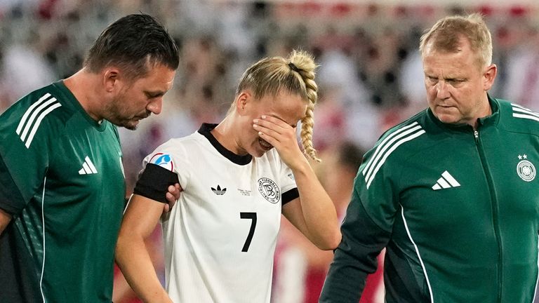 Germany's Giulia Gwinn leaves the pitch after getting injured during the Euro 2025, group C, soccer match between Germany and Poland at Arena St. Gallen in St. Gallen, Switzerland, Friday, July 4, 2025. (AP Photo/Martin Meissner)