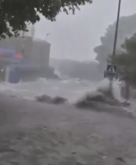 Flooded street during heavy rain.