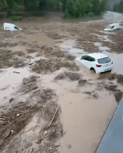 Cars submerged in floodwaters.