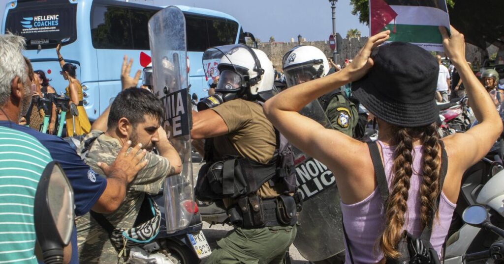 Riot police scuffle with pro-Palestinian demonstrators in Greece during visit by Israeli cruise ship