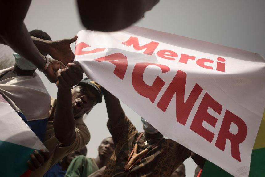Protesters hold a banner reading 