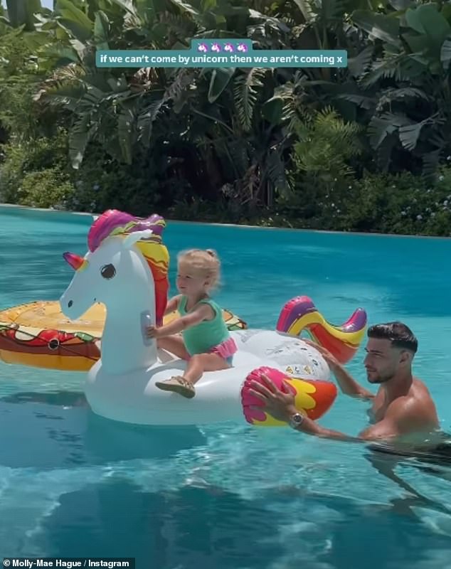 The influencer posted a video of boxer Tommy as he pushed Bambi along on an inflatable unicorn in the pool