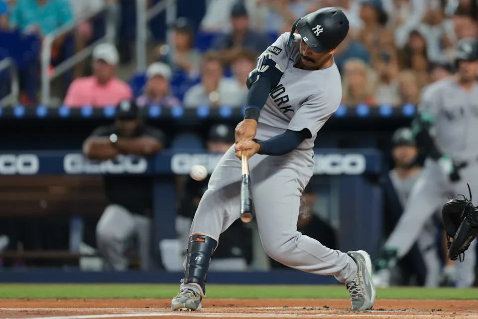 Aug 3, 2025; Miami, Florida, USA; New York Yankees center fielder Trent Grisham (12) hits a home run against the Miami Marlins during the first inning at loanDepot Park. Mandatory Credit: Sam Navarro-Imagn Images