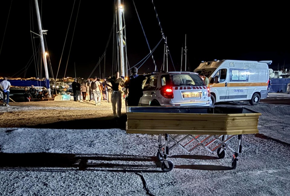 Coffin at Lampedusa harbor following migrant rescue.