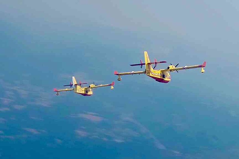 This recent photo provided by the Securite Civile shows two French Canadair water bombers flying over Spain. (Securite Civile via AP)