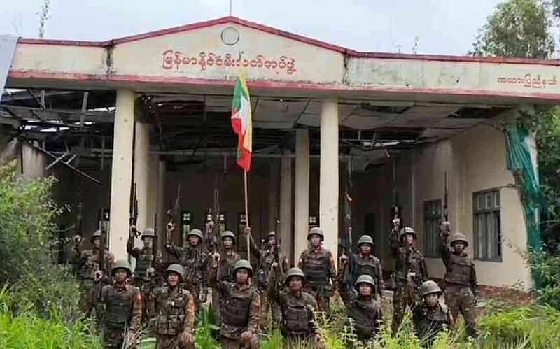 Army soldiers pose in front of the captured fire department station in Myanmar's eastern state of Kayah, which the military government claim to have recaptured from resistance forces, on Tuesday, Aug. 19, 2025 (Myanmar Military via AP)