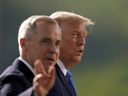 Prime Minister Mark Carney (left) and U.S. President Donald Trump arrive for a photo during the Group of Seven (G7) Summit at the Kananaskis Country Golf Course in Kananaskis, Alta., on June 16, 2025.