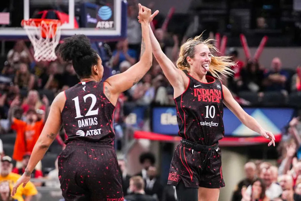 Indiana Fever forward Damiris Dantas (12) and Indiana Fever guard Lexie Hull (10) celebrate a 3-pointer Saturday, Aug. 9, 2025, during a game between the Indiana Fever and the Chicago Sky at Gainbridge Fieldhouse in Indianapolis.