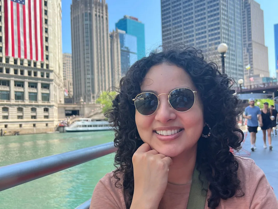 Giovanna Gonzalez in Chicago in front of an American flag.