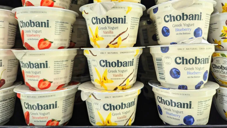 Stacks of Chobani yogurt on a supermarket shelf in three fruit flavors