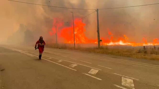 This still image taken from handout footage released by Spain's Emergency Military Unit (UME) shows military firefighters tackling a wildfifre near Yeres, northwestern Spain, on August 11, 2025.