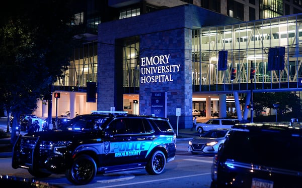 Police cars line the road outside of Emory University Hospital where a DeKalb County officer died during an active shooting incident on Friday, Aug. 8, 2025, in Atlanta. (Ben Hendren for the AJC)