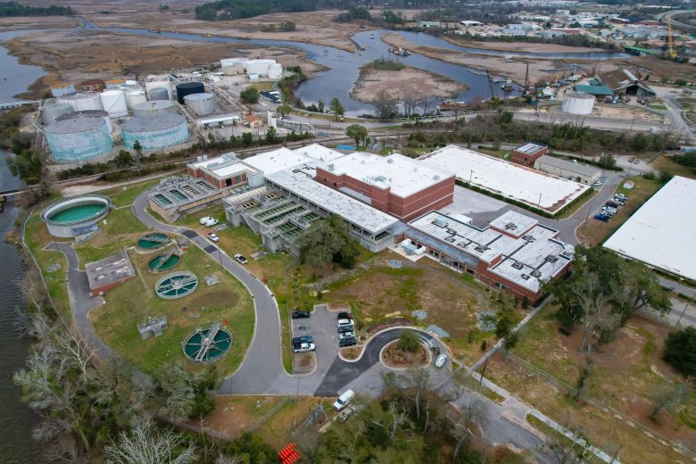 AN aerial view of an industrial water treatment facility, with a section of the Cape Fear River in the background.