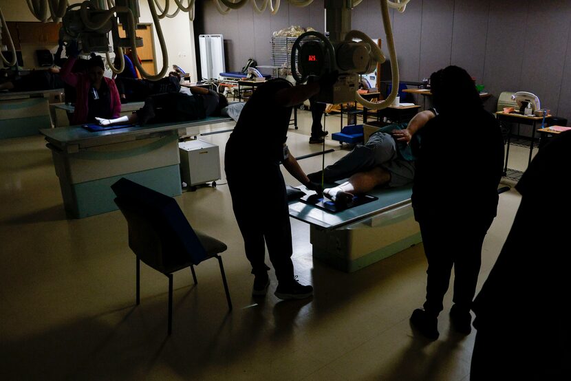 Students scan each other’s ankles as they learn radiology at the Dallas College Brookhaven...