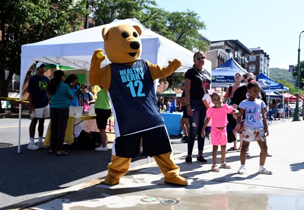 Community Health Center's mascot Healthy Berky pitches at the dunk tank during the Community Day at Penn Street sponsored by the Berks Community Health Center on Saturday, Aug. 9, 2025. (BILL UHRICH/READING EAGLE)