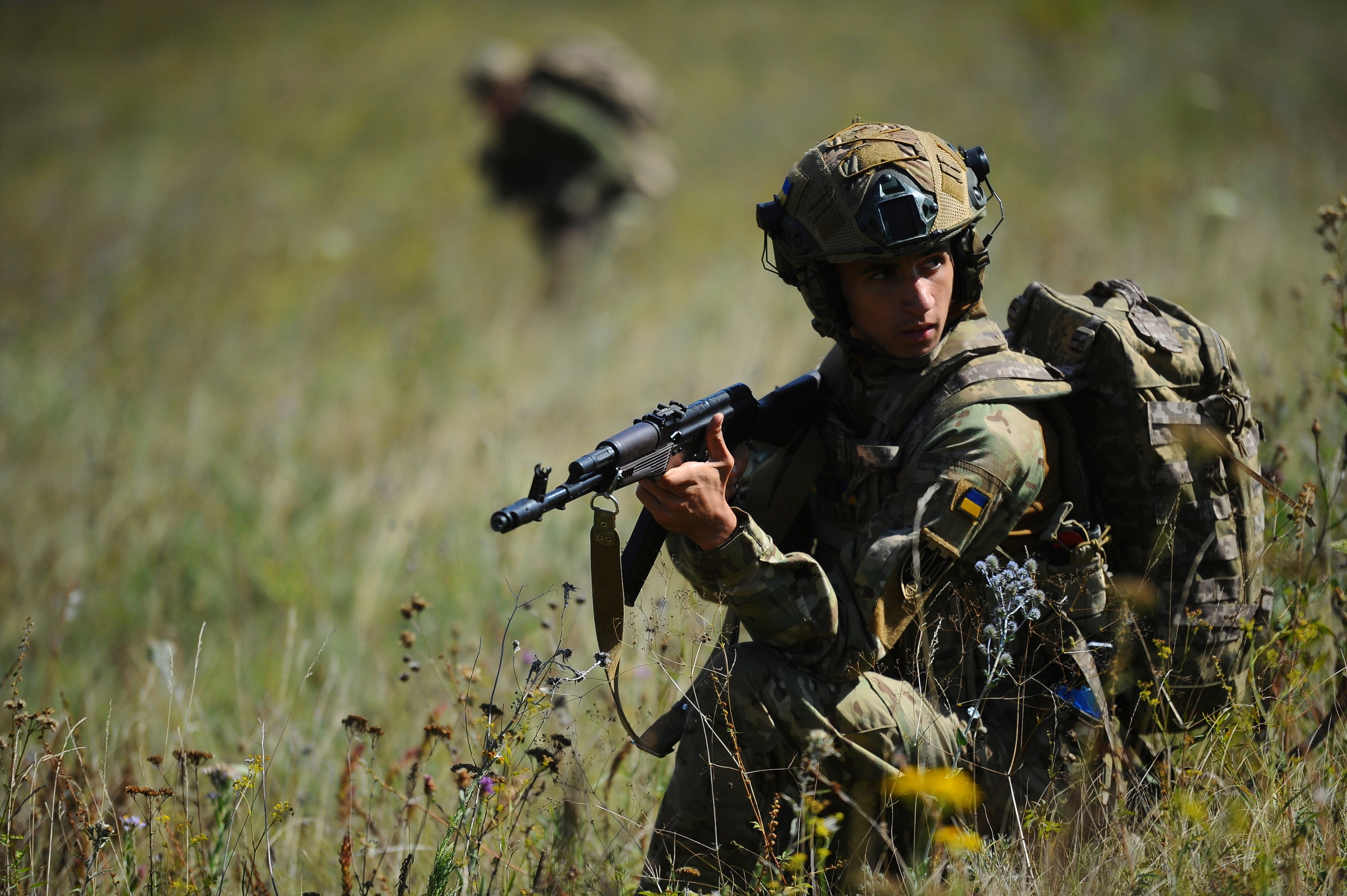 Soldiers aged 18 to 24 practice military skills on a training ground near Kharkiv, Ukraine