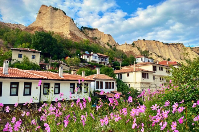 Traditional white houses in the historic town of Melnik, Bulgaria, nestled below the Melnik Sand Pyramids.