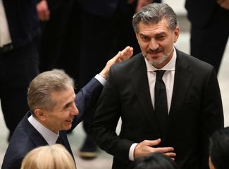 Georgian Dream founder Bidzina Ivanishvili talks to Mikheil Kavelashvili before his swearing-in as president at the parliament in Tbilisi. December 29, 2024.