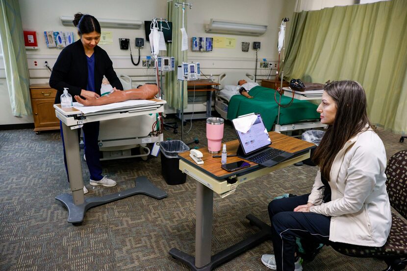 Leslie Johanson (right), IV instructor, assesses Cheryl Robin (left), second semester...