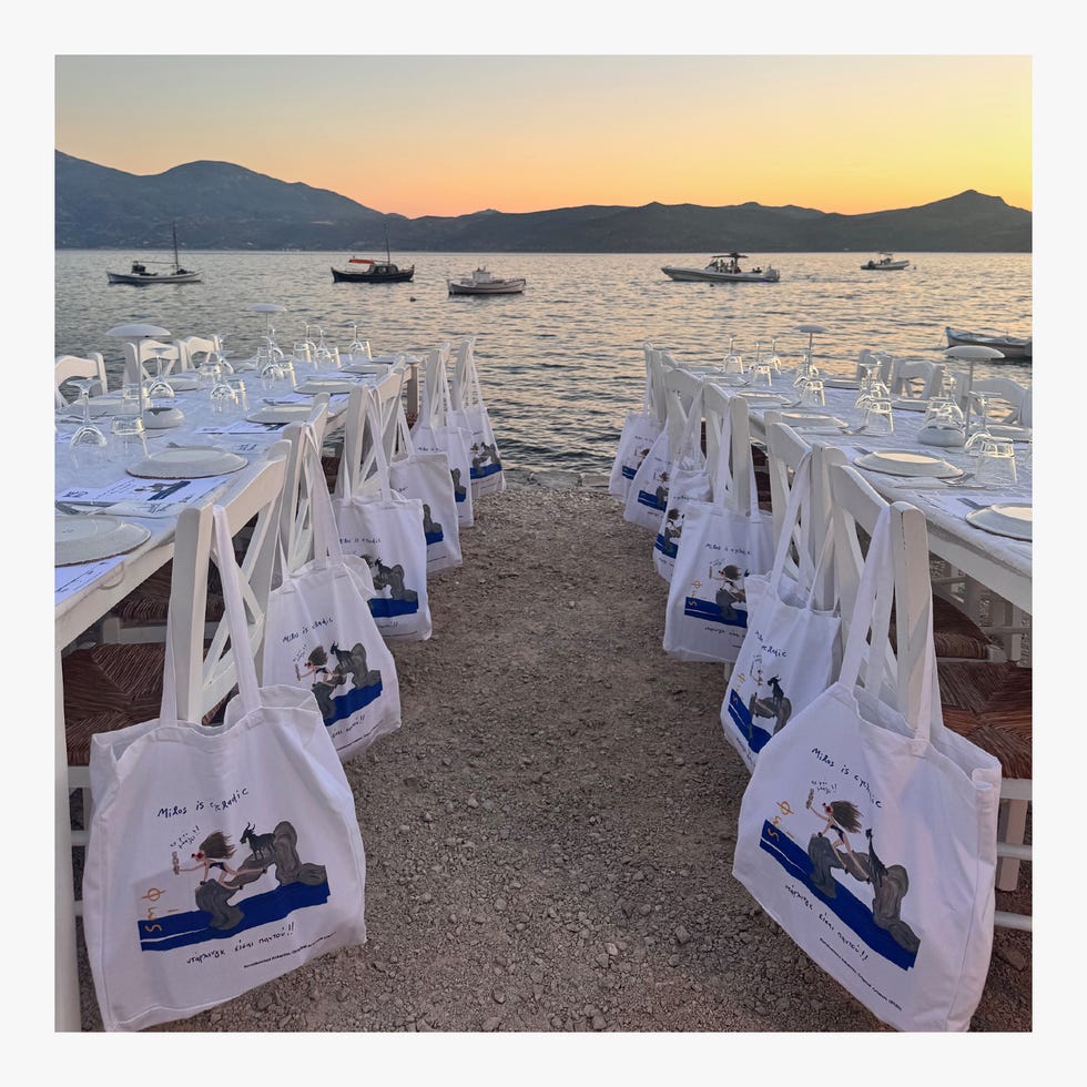 Dining setup with bags on a beach at sunset.