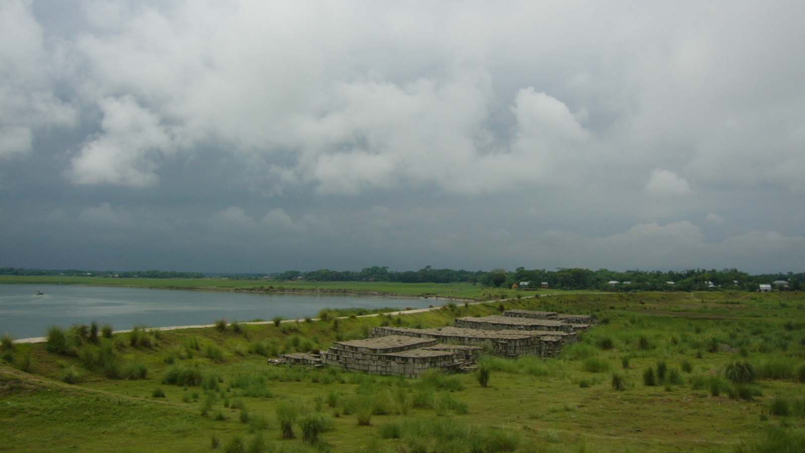A river next to lush green landscapes in Bangladesh