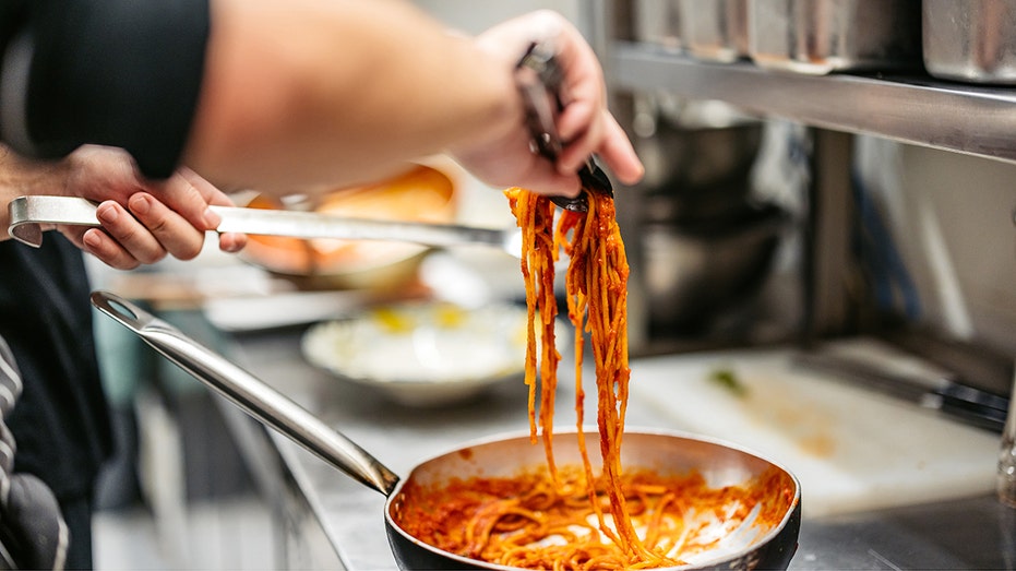 chef making Bolognese pasta