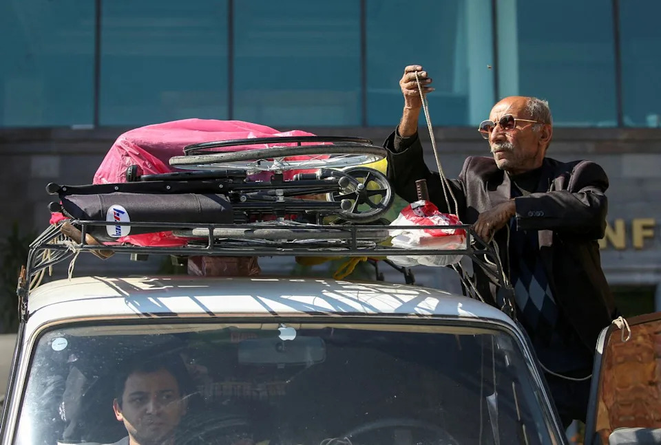 FILE PHOTO: Refugee Albert Petrosyan loads up a car as his disabled son Agasi sits inside before their departure from the town of Goris, Armenia, September 28, 2023. He and his family had fled the mountainous enclave of Nagorno-Karabakh earlier in the month after a shelling campaign by Azerbaijan.  The Canadian government is advocating for the safe right to return of some 120,000 ethnic Armenians to Karabakh as Armenia and Azerbaijan inch closer to peace after years of conflict over the region.  REUTERS/Irakli Gedenidze/File Photo